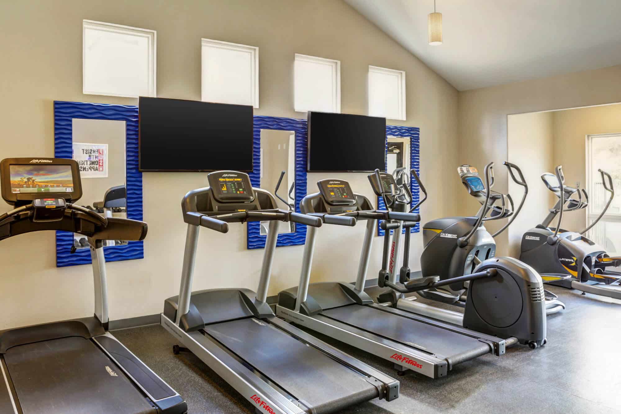 the outpost san marcos off campus apartments near texas state university resident clubhouse fitness center treadmills